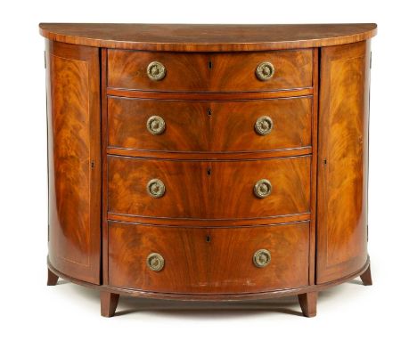 A GEORGE III FLAME MAHOGANY AND BOXWOOD STRUNG DEMI LUNE COMMODE IN THE MANNER OF GILLOWS the D shaped front with a center ba