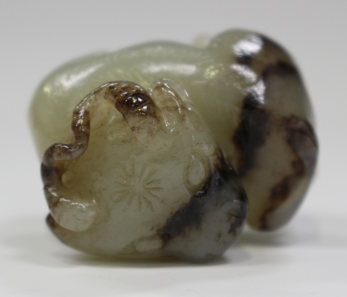 A Chinese Suzhou style jade pendant, carved in the form of a buffalo ...