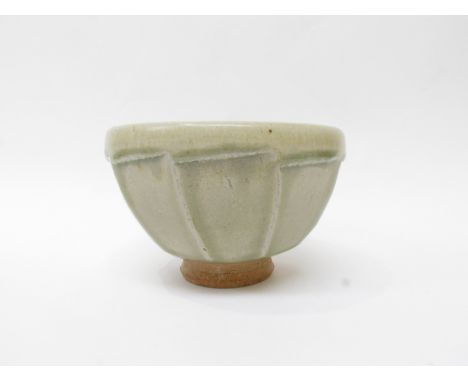 A studio pottery bowl, possibly by Richard Batterham (1936-2021) with cut facet sides, pale green glaze 11cm high x 17cm diam