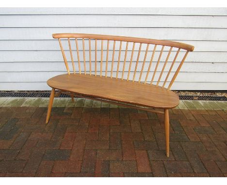 An Ercol bench in light elm, stick back. 118cm x 52cm x 78cm high