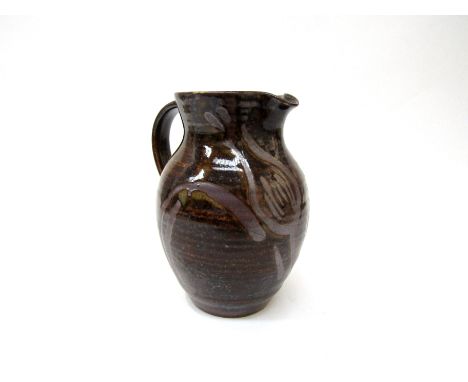 MICHAEL LEACH (1913-1985) A Yelland Pottery jug with a wax resist foliate detail. Impressed pottery seal. 17cm high