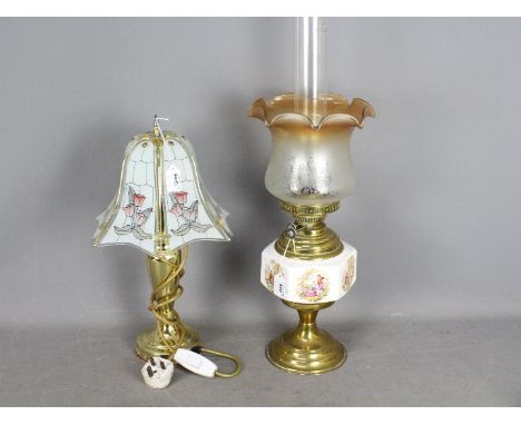 A brass oil lamp with ceramic reservoir, glass shade and chimney, approximately 63 cm (h) and a table lamp. [2]