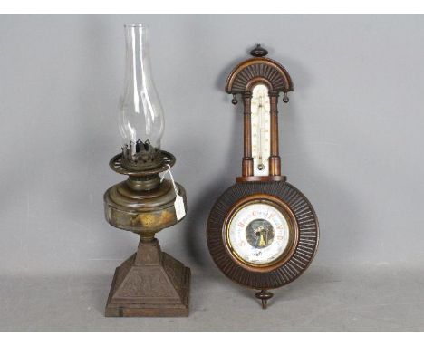 Lot to include a Victorian oil lamp with glass reservoir (lacking shade and with later chimney) and an oak cased barometer. [