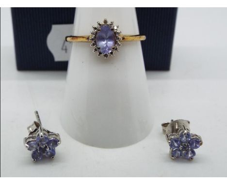 A silver gilt stone set dress ring, size O and a pair of stone set earrings in the form of flowerheads.