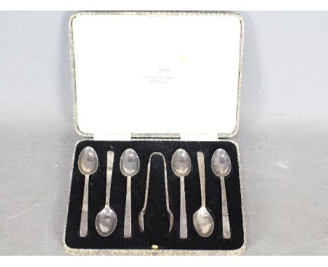 A George V cased set of silver coffee spoons comprising six spoons and sugar tongs, Sheffield assay 1935, sponsors mark for W