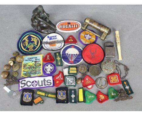 Lot to include cloth badges including scouting examples, cast metal sculpture of Mercury / Hermes, military cap badges and bu