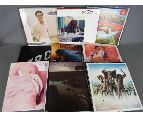 In excess of fifty 12" vinyl records to include Boston, Extreme, Def Leppard, Bon Jovi, The Band, Fleetwod Mac, Toto, Lynyrd 