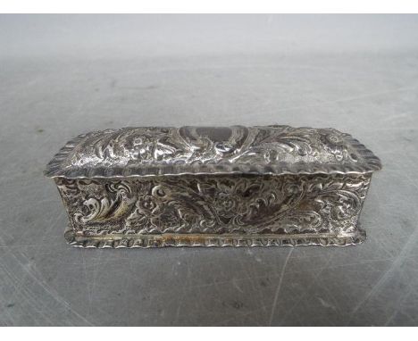 A late Victorian snuff box with foliate repousse decoration, Birmingham assay 1899, approximately 10 cm (l), 64 grams / 2 ozt