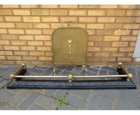 A brass and cast iron fire fender with black painted base, approximately 14 cm x 138 cm x 34 cm and a brass fire screen. [2]