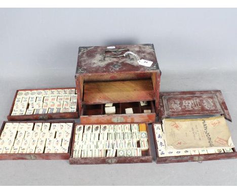 A vintage Mahjong set, wooden case with five drawers housing bone and bamboo tiles, approximately 16 cm x 24 cm x 16 cm.Condi