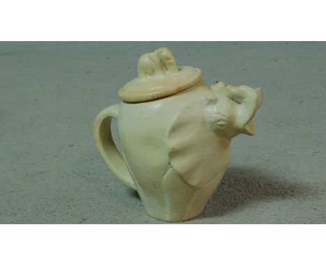 A carved vintage soapstone elephant teapot with baby elephant form finial. H.18cm 