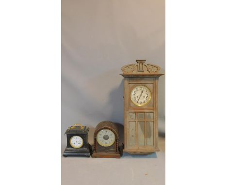 A collection of three antique clocks. One ebonised with a gilt metal handle and gilt engraved detailing, a white enamel dial 