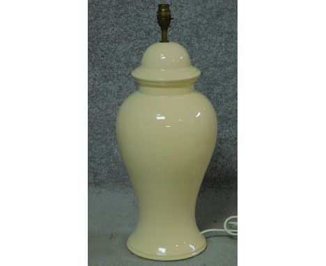 An Oriental style ceramic pale yellow glazed table lamp in the form of a lidded jar. H.58cm 