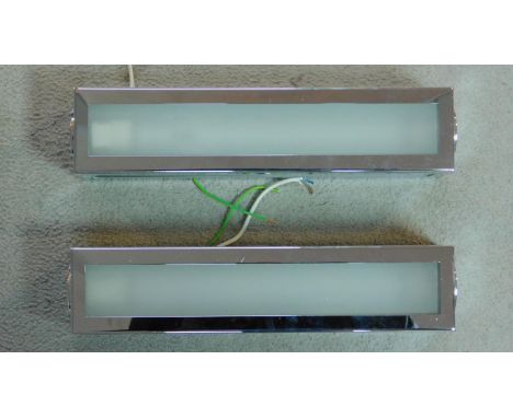 A pair of Art Deco style rectangular chrome and frosted glass wall lights by John Cullen lighting. H.33cm 