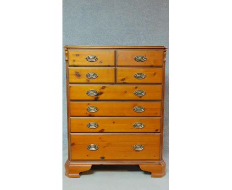 A Victorian style pitch pine tallboy chest with an arrangement of eight drawers on bracket feet. H.121 W.90 D.46cm