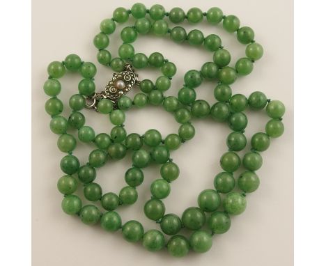 A double string of Chinese green hardstone beads the round beads gently taper in size from 9.2mm to 5.8mm, with a continental