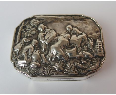 A Continental (probably Dutch) silver snuff box of rectangular form with shaped corners, the hinged cover embossed with a far