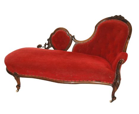 A Victorian walnut button back chaise longue and a pair of armchairs with carved scrolling foliate frames and on castors (3)