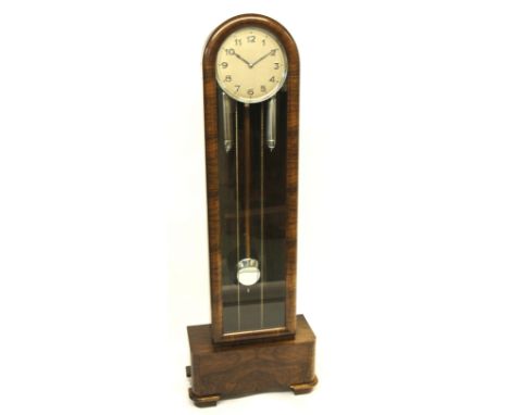 A German Art Deco walnut veneered longcase clock the silvered dial with chromed weights and pendulum, the hinged glazed door 