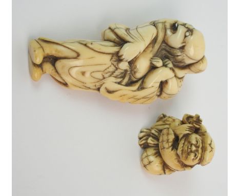 A Japanese ivory netsuke of a grotesque man holding an animal on his shoulder, 18th/19th Century, 7.5cm high and an okimono o