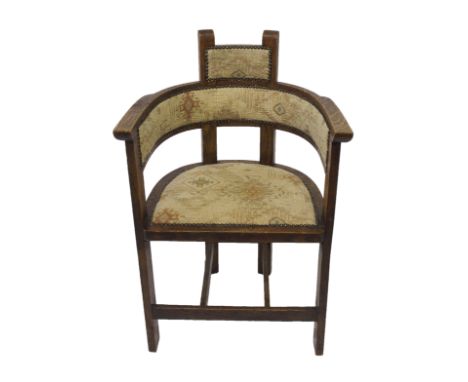 An Arts and Crafts oak open armchair with upholstered button back and seat, 88cm high