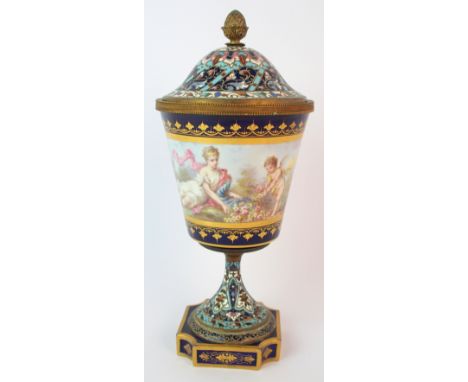 A Sevres pattern and champleve enamel vase and cover painted with a classical female figure and cherub on a lakeside gatherin