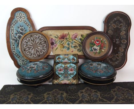 A group of Victorian beadwork comprising; two foot stools, two circular teapot stands, three tea trays and two banners (8)