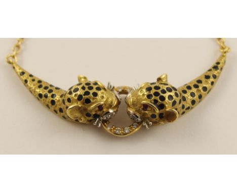 An 18ct yellow gold leopard necklace the flexible pendant leopards have black enamel spots, red gem set eyes and are holding 