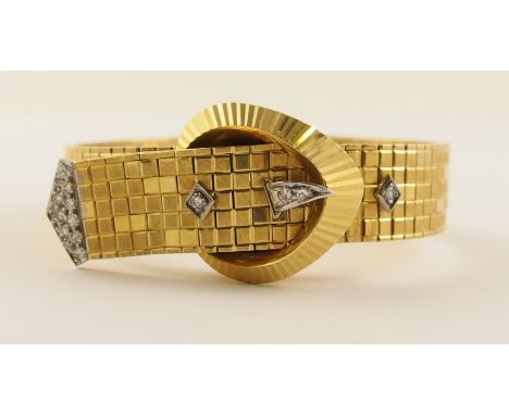 An 18ct gold 1960's diamond set cocktail watch with a diamond set buckle shaped cover over the watch face, the strap with squ