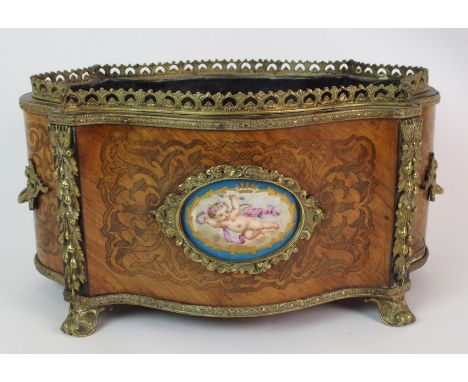 A Louis XV style parquetry oval shaped planter with Sevres style panel of a cherub, on a foliate inlaid ground divided by gil