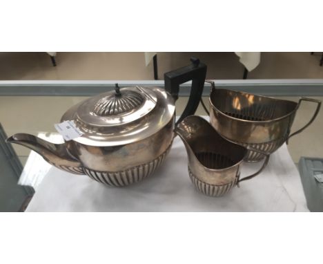 A three-piece silver tea service, by Martin Hall & Co Ltd, Birmingham 1922 and 1923, of oval, part fluted form, teapot engrav