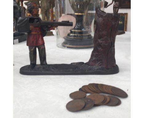 A 19th century cast metal moneybox of a man with rifle shooting at tree trunk with plaque dated 1891