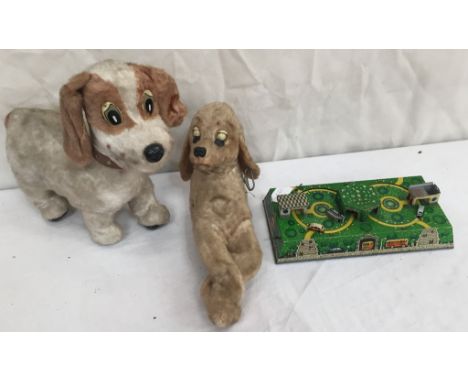 Two 1960s Japanese automaton dog toys; together with a tin plate coach toy