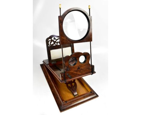 A Victorian figured walnut tabletop stereoscope with sliding fret cut main panel and hinged eyepiece, sold with two boxed set