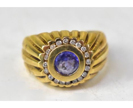 A tanzanite and diamond college-style gold ring, the 14ct gold ring set with a flush fit round tanzanite, approx 0.8ct, withi