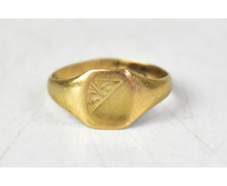 A small 9ct gold signet ring, with diagonally separated top, floral design to one half and blank to the other, size M, approx