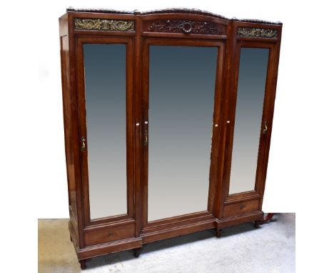 An early 20th century French Empire Revival walnut and kingwood two-piece bedroom suite, comprising a large triple wardrobe w