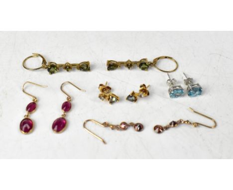 Five pairs of 9ct gold earrings comprising a pair of double bezel set ruby drops on a French hoop, a pair of Mystic Topaz and