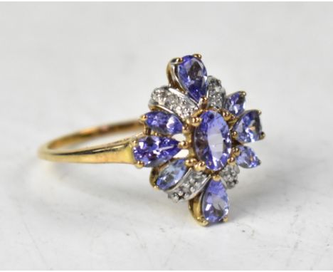 A 9ct gold tanzanite and diamond ring, the flowerhead design comprising oval, pear-shaped and marquise cut claw set tanzanite