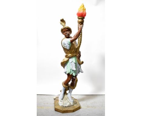 A large fibreglass Blackamoor figural lamp, holding torch aloft, height 140cm.