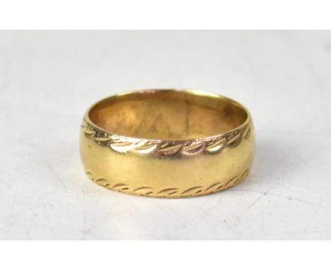 A 9ct gold wide band ring with textured patterned edge, size W, approx 6.5g.