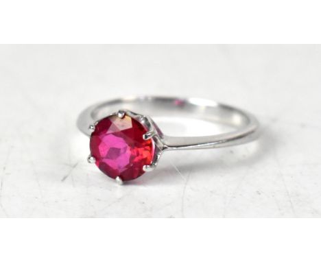 A 9ct white gold ring, with a claw set round red topaz, size O, approx 2.3g.