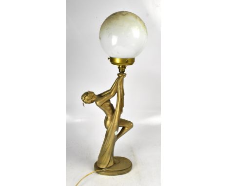 An Art Deco style gilded plaster table lamp in the form of a nude female, with globular shade, height 79cm.