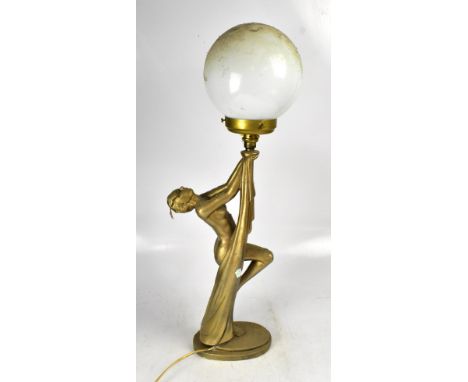 An Art Deco style gilded plaster table lamp in the form of a nude female, with globular shade, height 79cm.