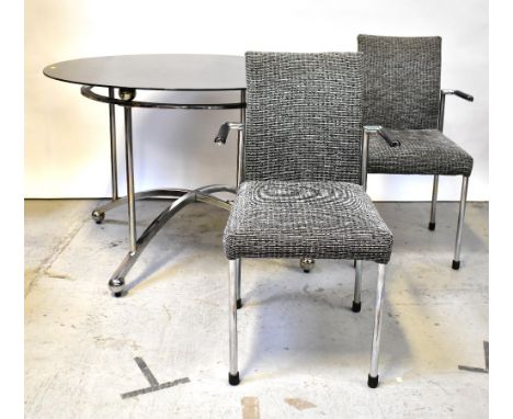 A 1960s designer circular black glass-topped dining room table on architectural chrome plated/stainless steel frame with arch