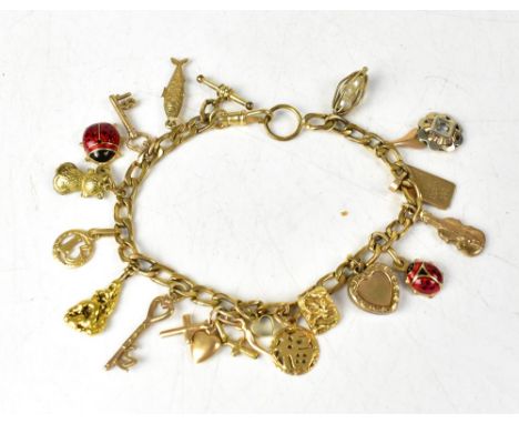 A charm bracelet comprising seventeen mixed gold charms, to include examples marked '9CT', others marked '18CT' and some unma