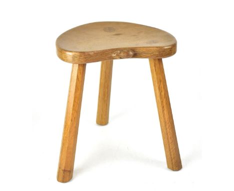 WORKSHOP OF ROBERT 'MOUSEMAN' THOMPSON; an oak stool with dished kidney-shaped seat and octagonal tapering legs, height 36cm.