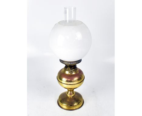 A brass oil lamp with opaque shade and funnel, height 51cm.