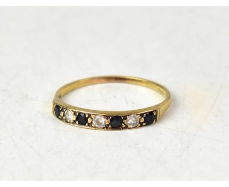 A 9ct gold sapphire and white stone half eternity ring, the straight pavé set band of four sapphires separated by three cut w