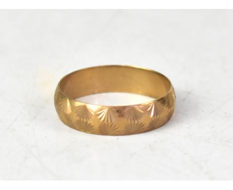 A large 9ct gold band ring, with a double row of mirrored floral pattern, size Z, approx 3.8g.